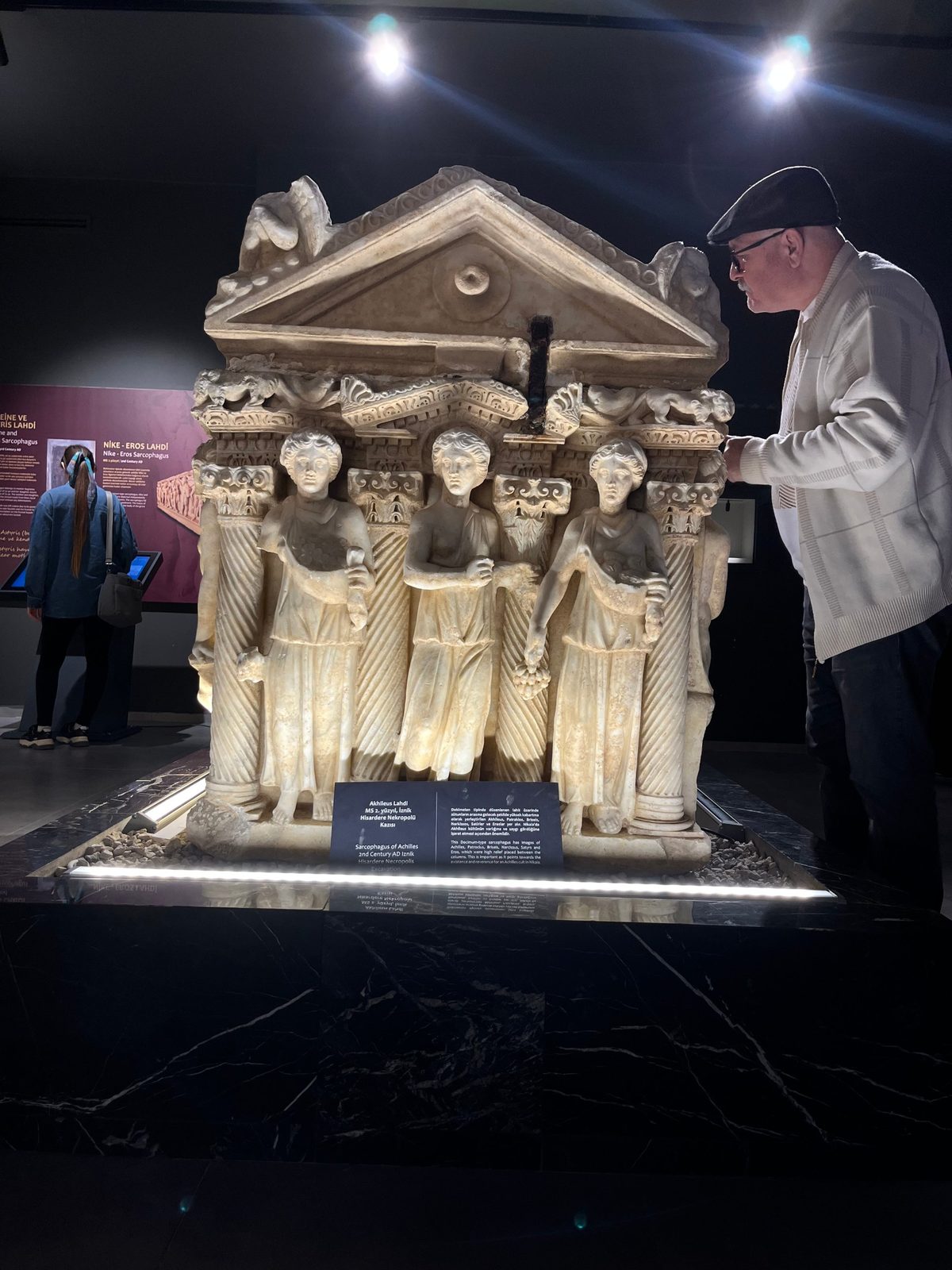 A visitor taking a close look at a sarcophagus in the İznik Museum.